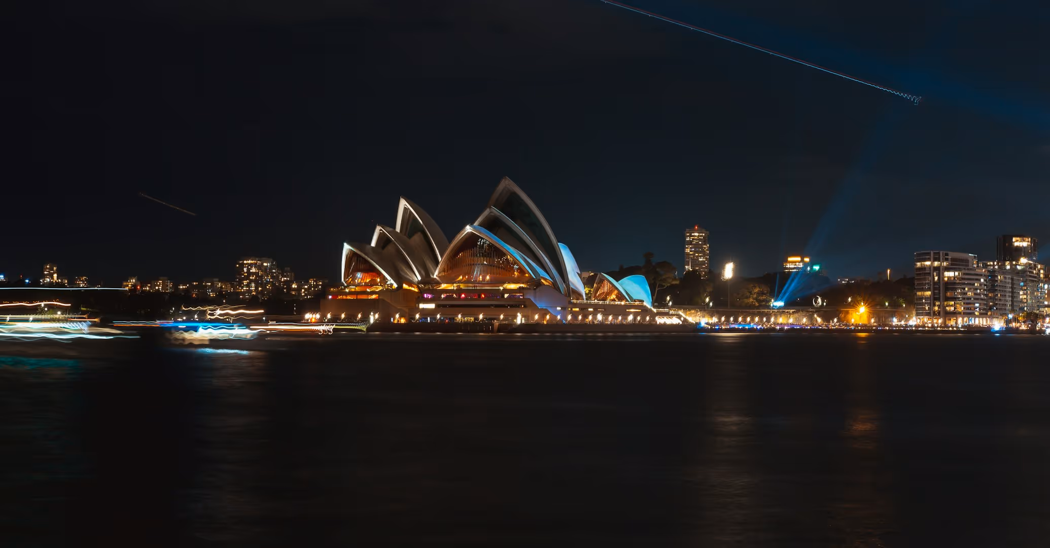 A long exposure shot of the Sydney Opera House at night.